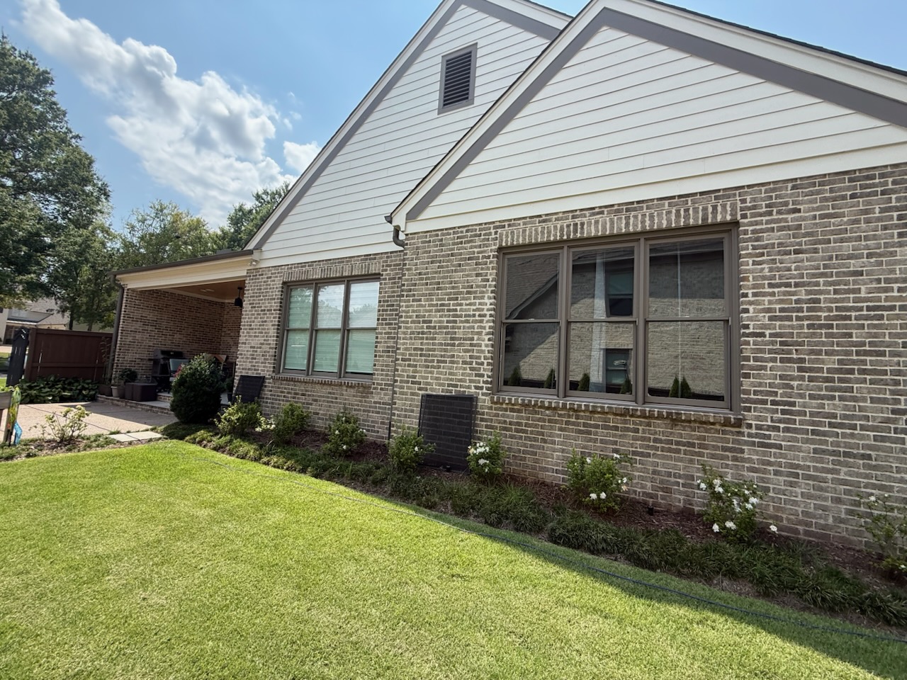 Brick ranch home with clean picture windows